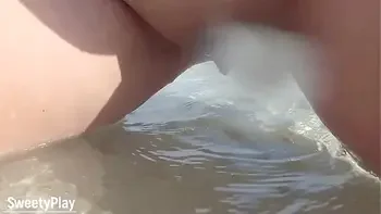 Shaved pussy peeing on public beach