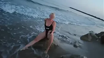 Blonde shows tits and sucks cock on a public beach