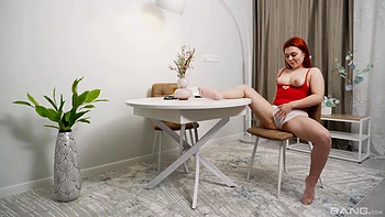 A cute girl named Fessa Lux plays with her pussy on a chair, achieving orgasm.