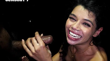 Latina slut Harley Haze sucks cock through a glory hole, showcasing her deepthroat skills.