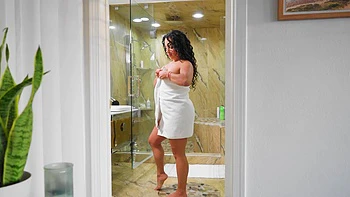 A hot latina gives a blowjob to her man in the bathroom, showcasing sensual passion.