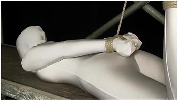 Babe Wrapped In White Zentai Suit Enjoys To Be Bondaged To A Metal Pole