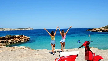 Two hot girls have fun on the beach with their bikinis on