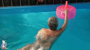 Gorgeous mature blonde Jitka is touching her shaved pussy in the pool